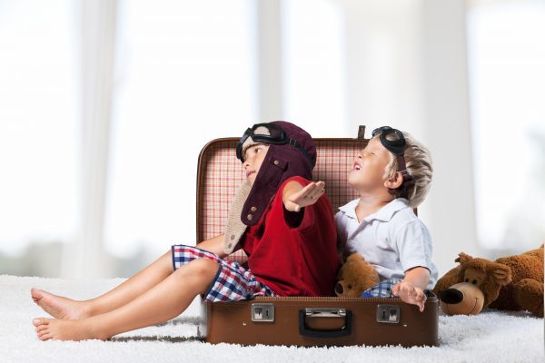 two boys in the form of an aircraft pilot and traveler playing in her room